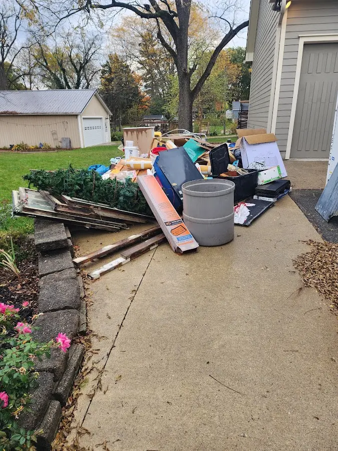 Dumpster being loaded with debris for Estate Cleanout Dumpster Rental in Dunedin